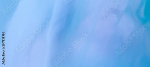 Bright cyan sheer fabric background with delicate wrinkles, diffused illumination, ethereal atmosphere, soft textile texture, and modern abstract aesthetic.
