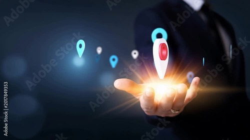 Businessperson holding glowing retail store location icon, local business and franchise search concept with map pins, shop network, digital marketing, geolocation and commercial se