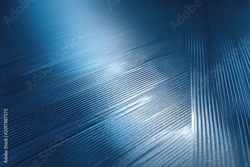 A metallic blue background with brushed texture and geometric embossing, reflecting subtle light for a sleek industrial look.