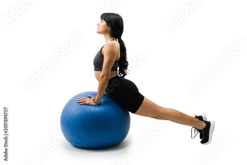 Quadro su tela Latin woman working out with stability ball doing cobra pose for core strength a