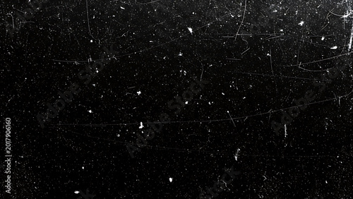 Black background with white scratches and specks