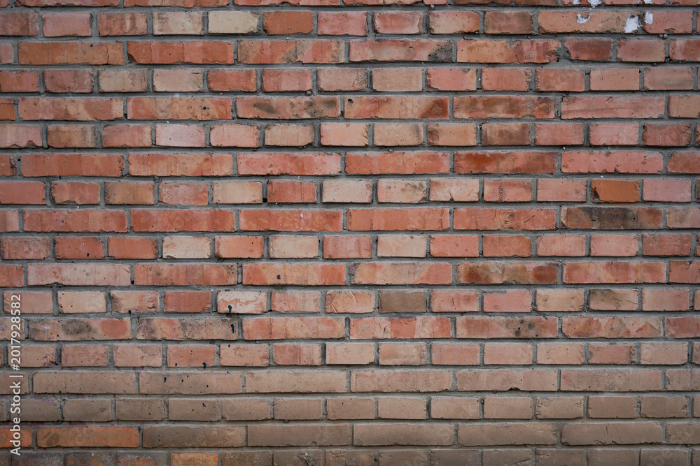 Obraz premium Close up view of weathered red brick wall texture