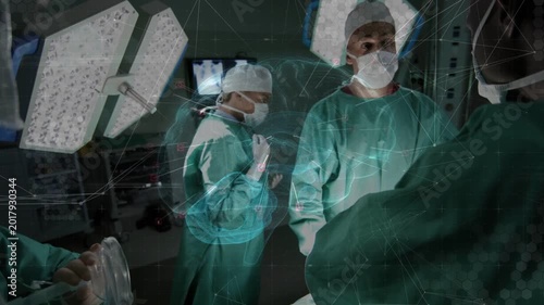 Surgical team responding as teal AR overlay projecting over table, prepping ambu mask for surgery