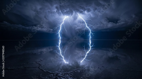 Dramatic close-up of a bright lightning bolt striking the ground with a dark and ominous stormy sky in the background.