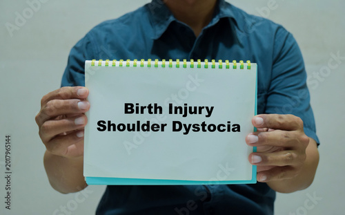 Konstfotografi Businessman holds in hands a book with the name of the birth injury shoulder dystocia