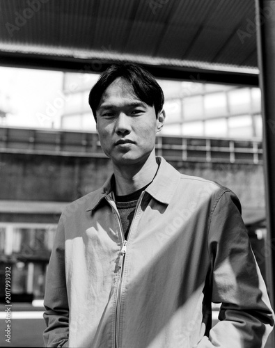 Young asian man standing outdoor in analog monochrome film style