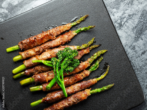 Asparagus dish with meat on a plate