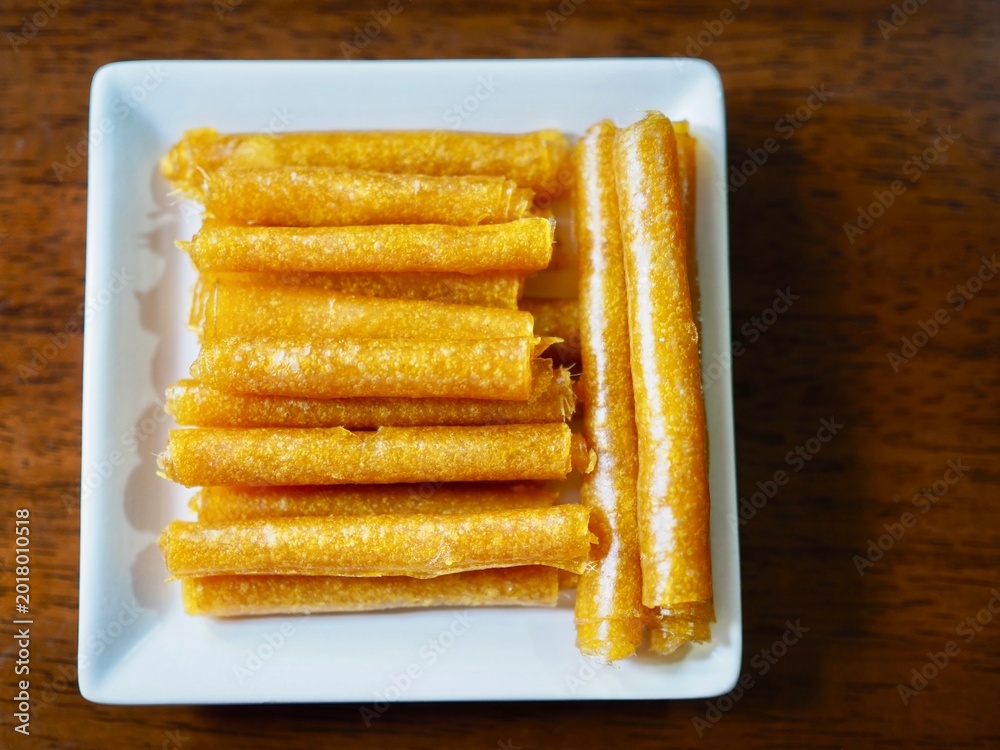 Fototapeta premium The mango paste was dried in the sun and placed on a plate. It looked appetizing and delicious.