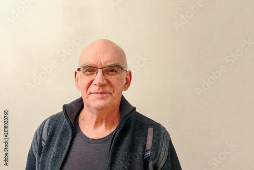 Canvas Print Portrait of a cheerful, bald, bespectacled elderly man.
