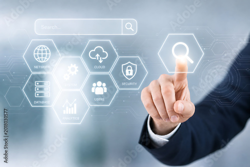 A businessman interacts with a futuristic interface selecting a human icon