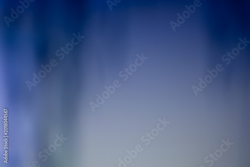 Abstract background with smooth blue and grey color gradients. Soft blurred texture creates a serene, professional atmosphere for creative design, corporate slides, and digital art.