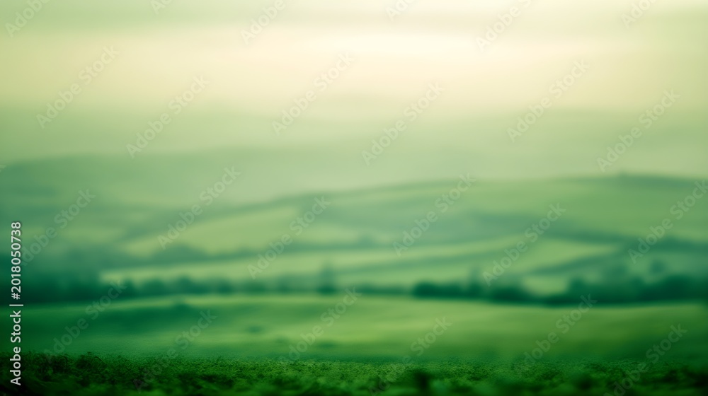 Fototapeta premium Soft focus green rolling hills under a pale sky landscape