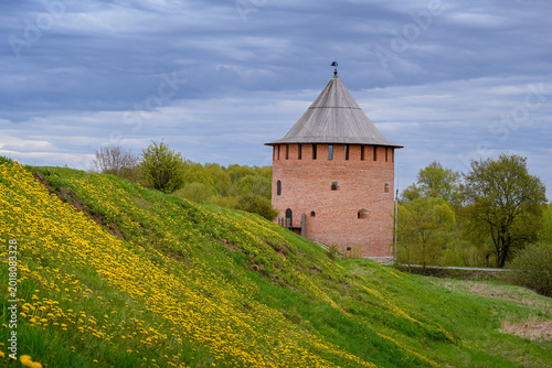 Bild auf Leinwand The brick Alekseevskaya Tower near the ramparts of the ancient fortress in Velik
