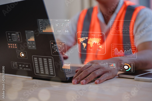 Male engineer using computer laptop working on site analytic data charts for workflow and programming.