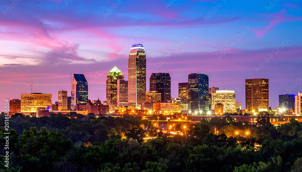 Obraz premium A city skyline at dusk with vibrant sky and lit buildings