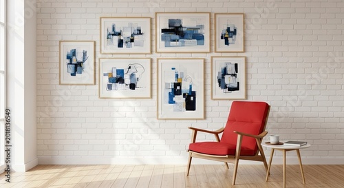 Gallery wall with set of six framed abstract art prints in blue and gold on white brick wall, modern red armchair in bright living room.