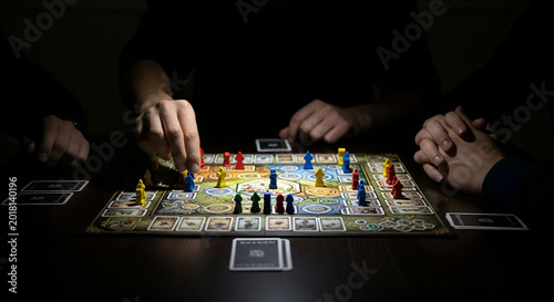 People playing a board game together in the dark