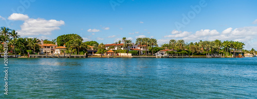 Vacation building in summertime. Luxury waterfront house. Hotel building. Residential architecture. Modern building Miami. Residential apartment in waterfront city. Waterfront landscape with house