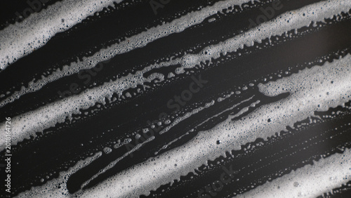 Foto Diagonal White Foam Streaks on Black Background, Abstract Texture