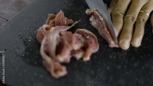 Chef Carefully Slicing Fresh Raw Beef On A Cutting Board