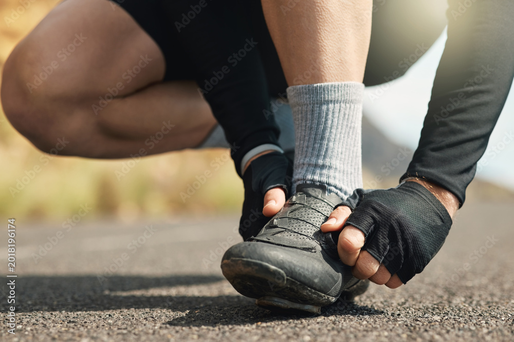 Obraz premium Hands, athlete and person with laces outdoor to secure shoes, preparation and fitness exercise. Runner, footwear and lacing system for proper fitting, getting ready and cardio training for wellness