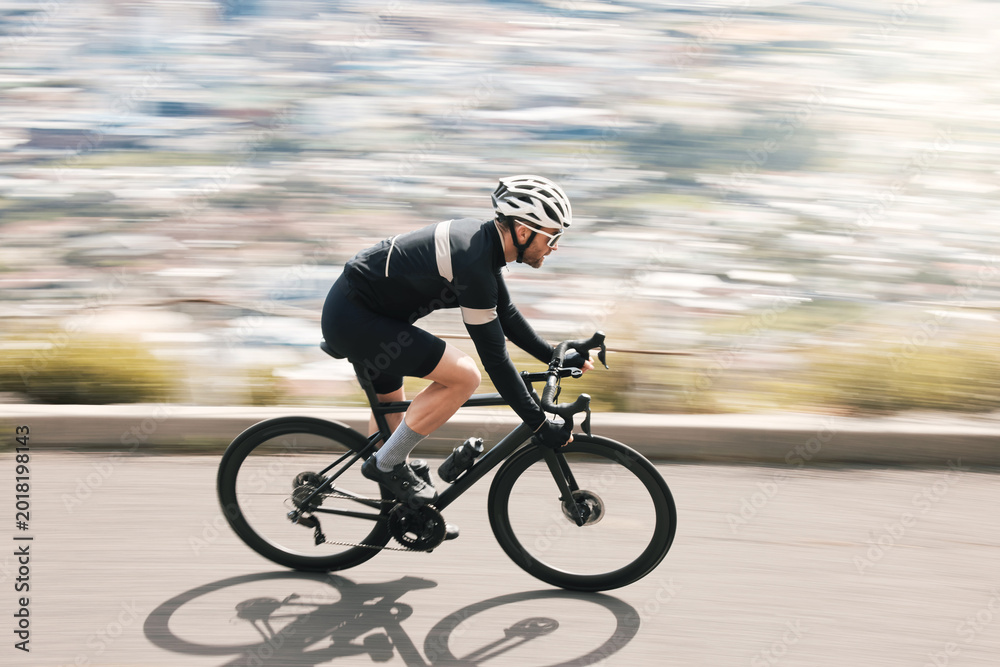 Naklejka premium Fitness, bike or cyclist on road with motion blur, endurance training or speed in cardio workout. Fast, space or man outdoor with bicycle, physical activity or riding practice in sports hobby.