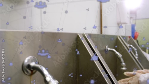 Gloved hands pressing PUSH dispenser turning faucet rinsing for hygiene while social icons drifting