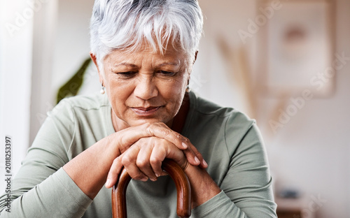 Tableau sur toile Sad, thinking and old woman with walking stick in home for grief, memory or lonely in retirement