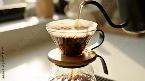 Capturing the serene art of pour-over coffee brewing, with hot water gently cascading over freshly ground beans into a clear glass carafe, creating an aromatic morning ritual