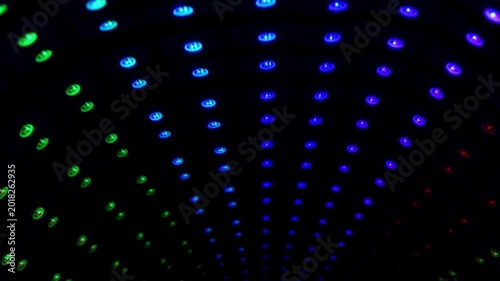 Rows of bright blue circular lights arranged in a structured arched pattern with a high-contrast glow effect.