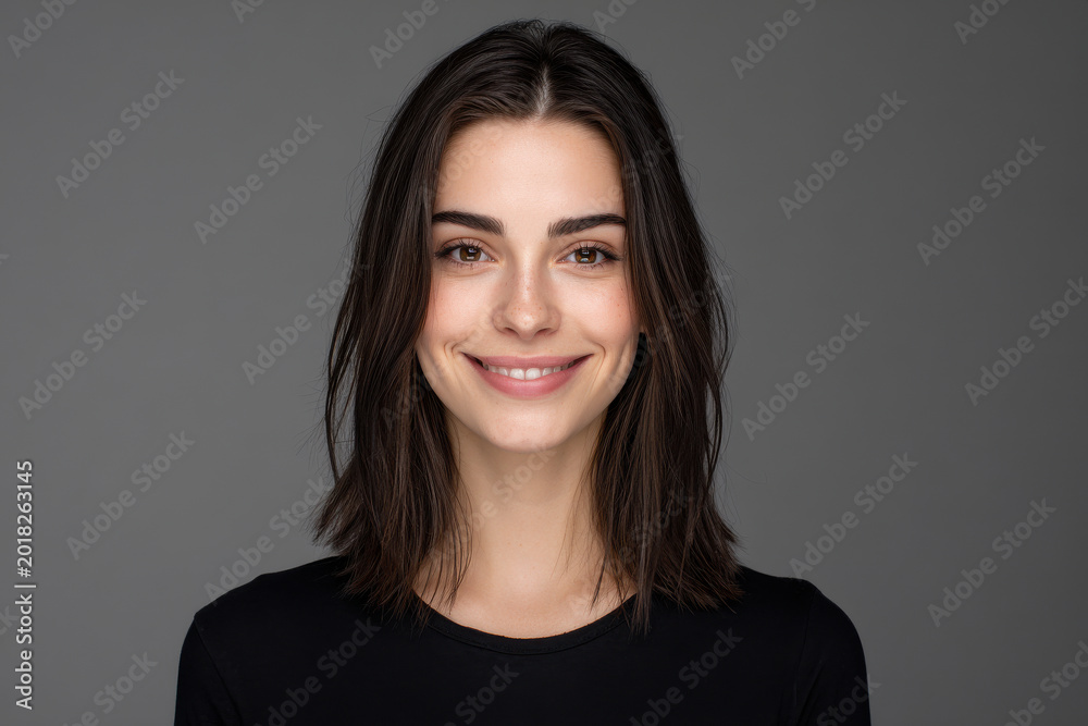 Obraz premium happy person stands in neutral pose against clean gray background radiating joy