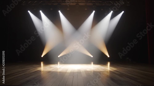 Empty performance stage with rustic wooden floorboards illuminated by moving white spotlights and smoke effects.