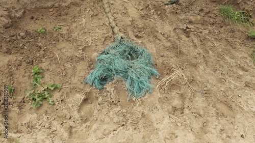 Boat mooring rope attached to sand dune stock footage