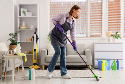 Female janitor mopping floo...