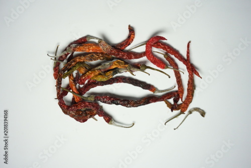Quadro su tela Close up of moldy dried red chili peppers on white background