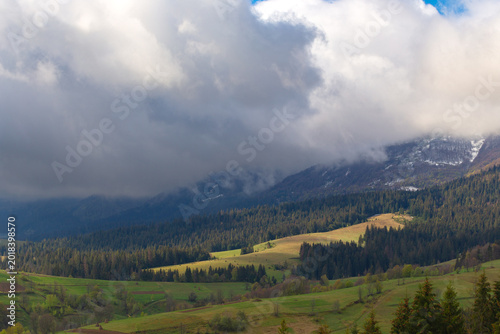 Dramatic clouds of the autumn Carpathian mountains at early morning in the sunrise.