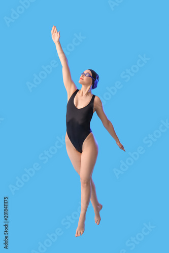 Female swimmer on blue  bac...