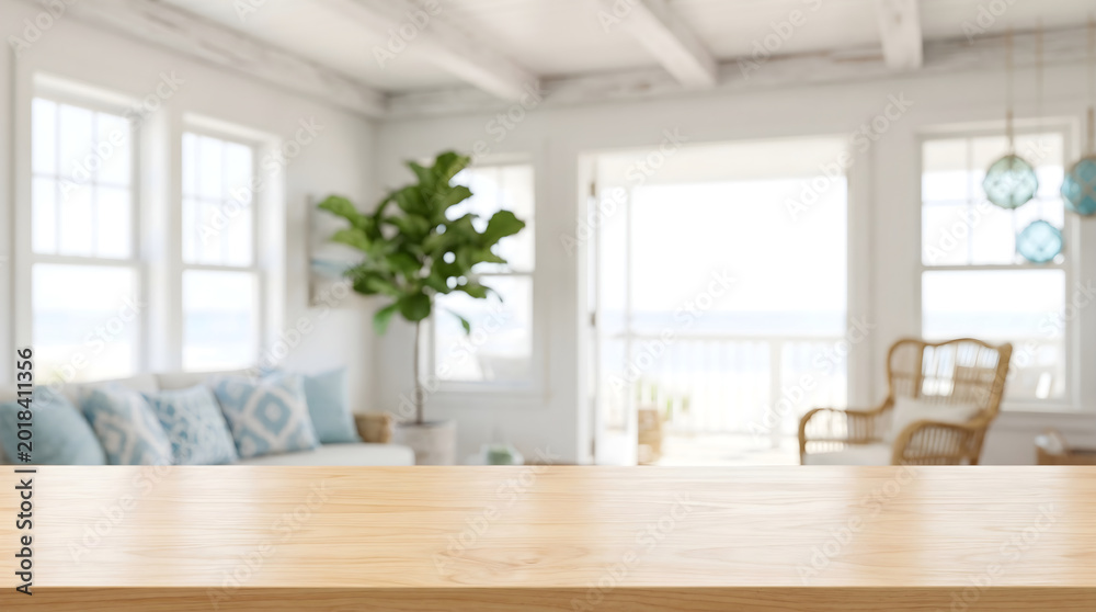 Fototapeta premium Empty Wooden Table Top Surface Background with Blurred Coastal Living Room Interior for Product Display Mockup