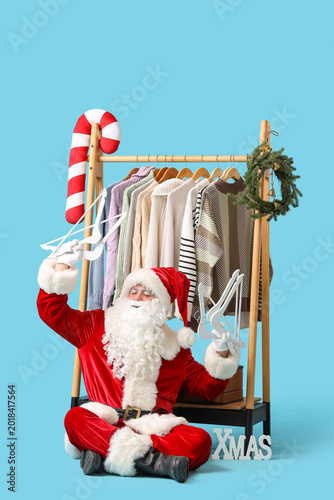 Santa Claus holding hangers...