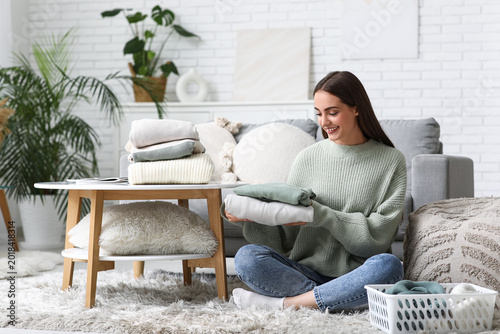 Young woman with stack of w...
