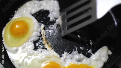 making fried eggs for breakfast