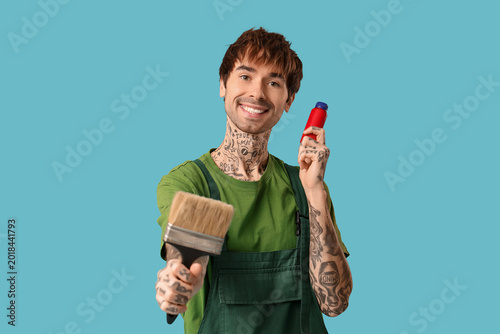 Happy male painter with bot...