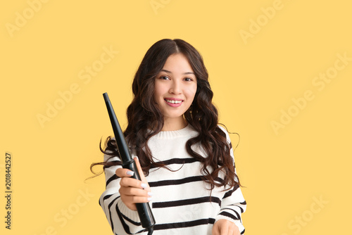 Young Asian woman with curl...