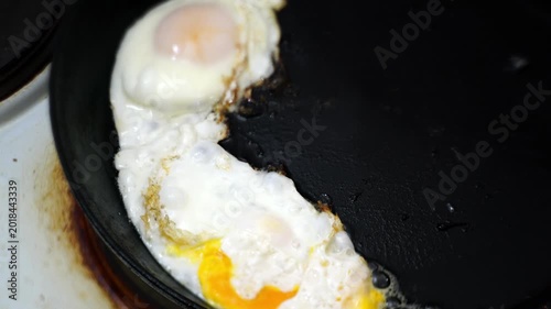 making fried eggs for breakfast