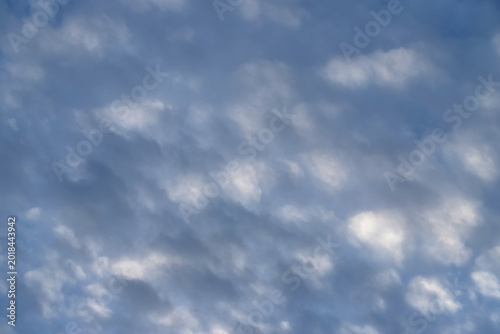 Schilderij op canvas Soft blue sky filled with mottled altocumulus clouds creating a peaceful texture