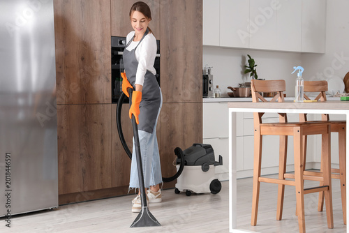 Female janitor hoovering fl...