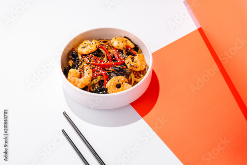 Delicious shrimp and noodle dish served on a bright and simple background