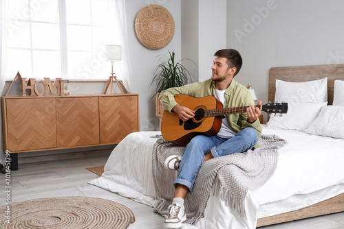 Young bearded man playing g...