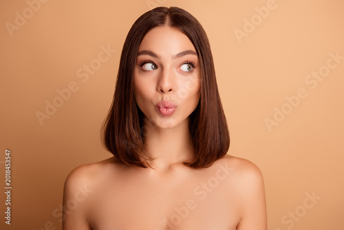 Εκτύπωση καμβά Natural beauty portrait of a young woman with a sleek bob hairstyle on a beige b