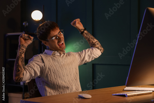 Happy young tattooed man wo...